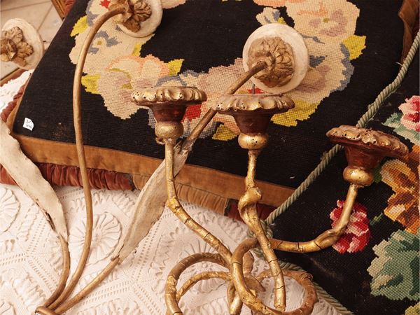 Three sconces in carved and gilded wood
