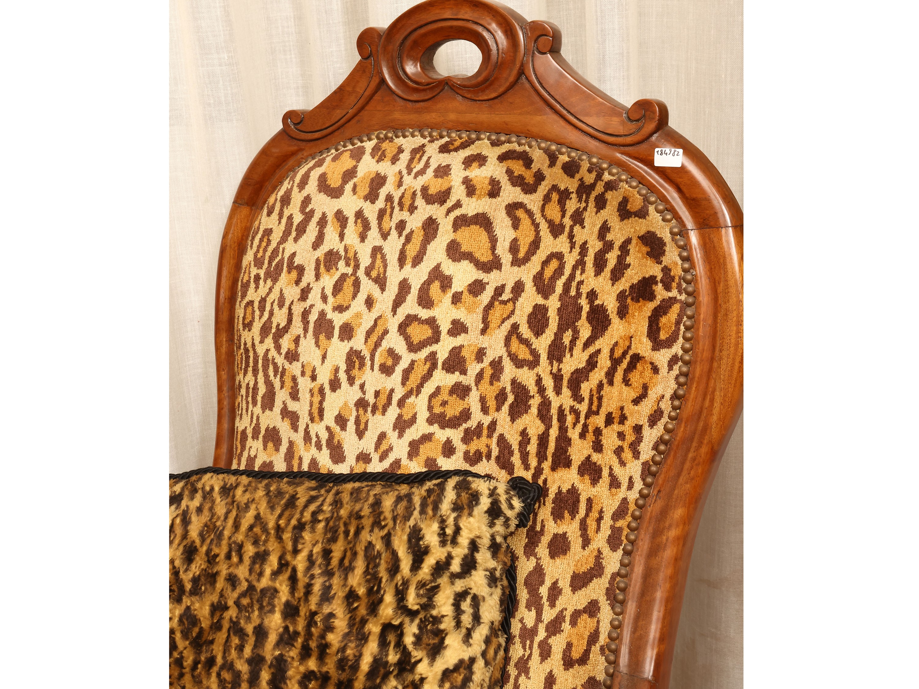 Poltrona in noce, rivestita in tessuto animalier, seconda metà del XIX secolo