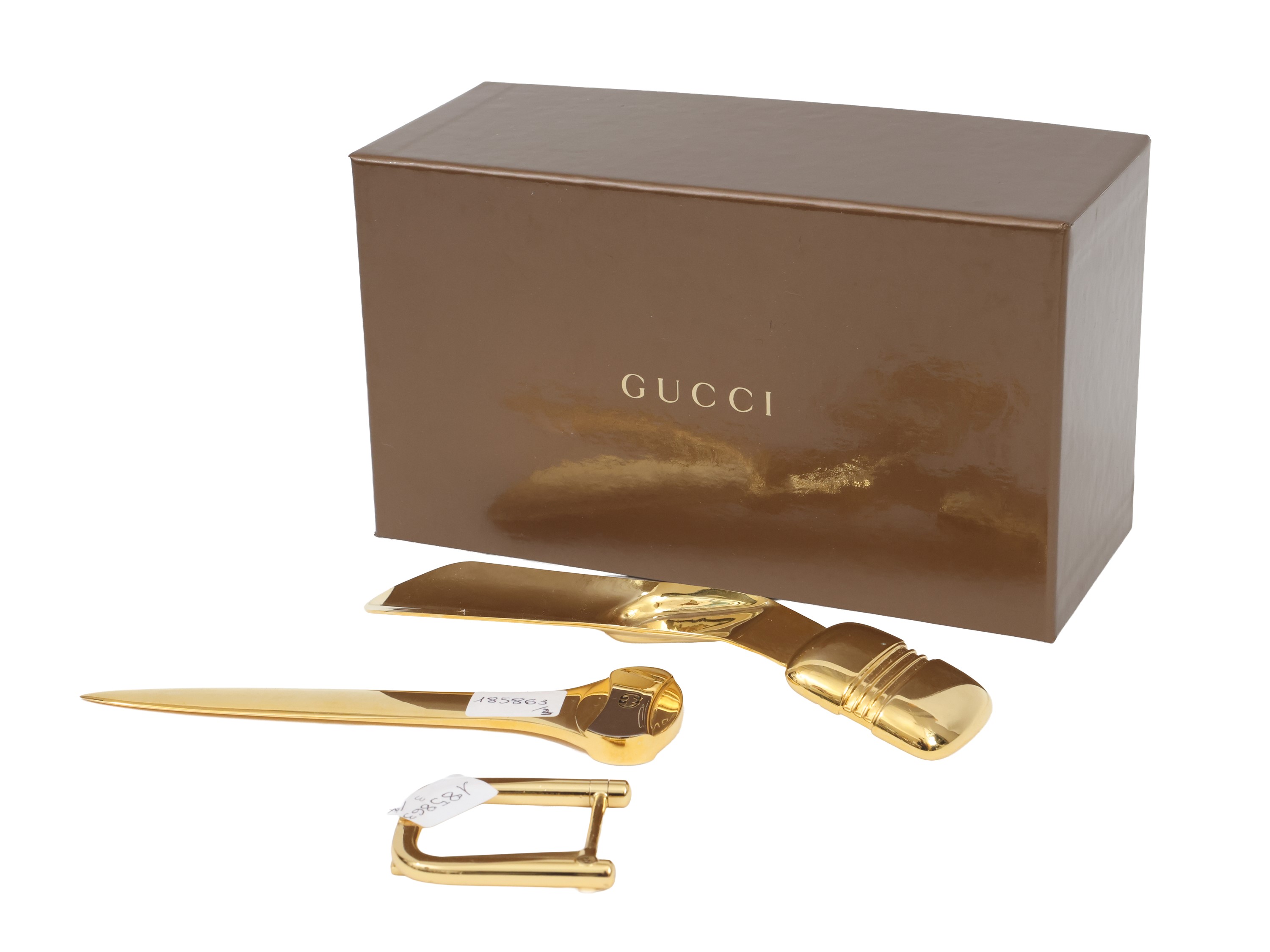 Gucci - Tre accessori in ottone dorato