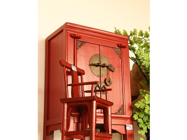 Two miniatures in red lacquered wood