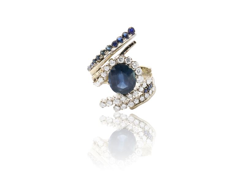 Anello contrariè in oro bianco con diamanti e zaffiro ovale