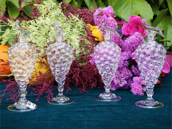 Series of four small blown glass passito bottles