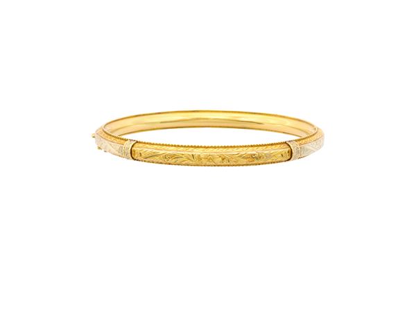 A 18k white and yellow gold bangle bracelet