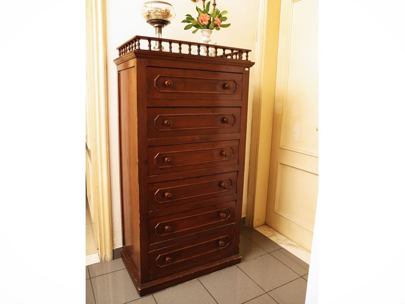 Cassettiera in legno tenero, piano con bordo a ringhiera e sei cassetti modanati