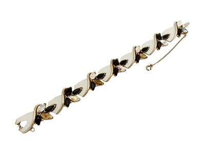 Trifari, Bracciale semirigido a placche in metallo dorato con smalto e strass