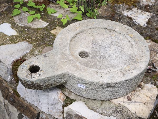 Two ancient stone millstones
