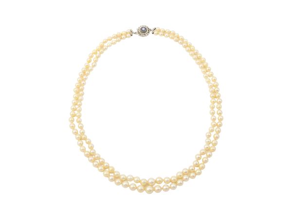 Two-strand necklace of white cultured pearls and 18K white gold clasp