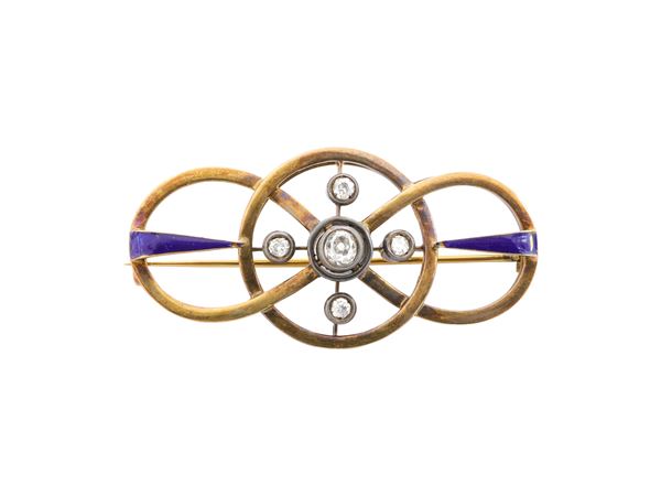 A diamonds and blue enamel brooch in 14K gold and silver