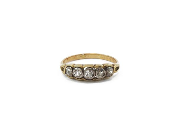 A diamonds riviere ring in A 18K yellow gold and silver