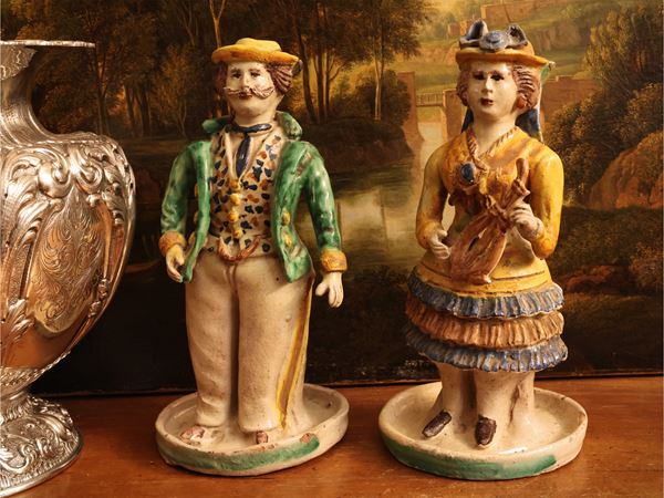Pair of anthropomorphic candlesticks in polychrome ceramic