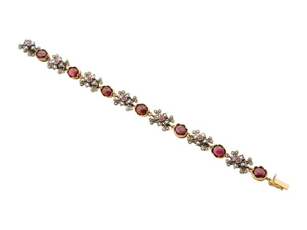A garnets and rubies bracelet in 18K yellow gold and silver
