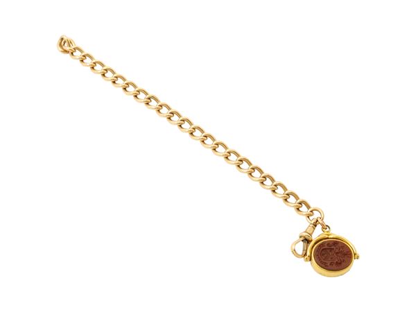 A 9kt yellow gold bracelet with semiprecious stone pendant with 18K gold frame