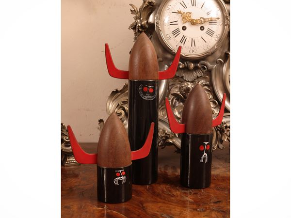 Three container figures in enamelled metal