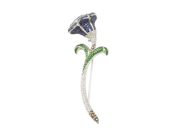 A 18Kt white gold, small diamonds, sapphires and tsavorites brooch