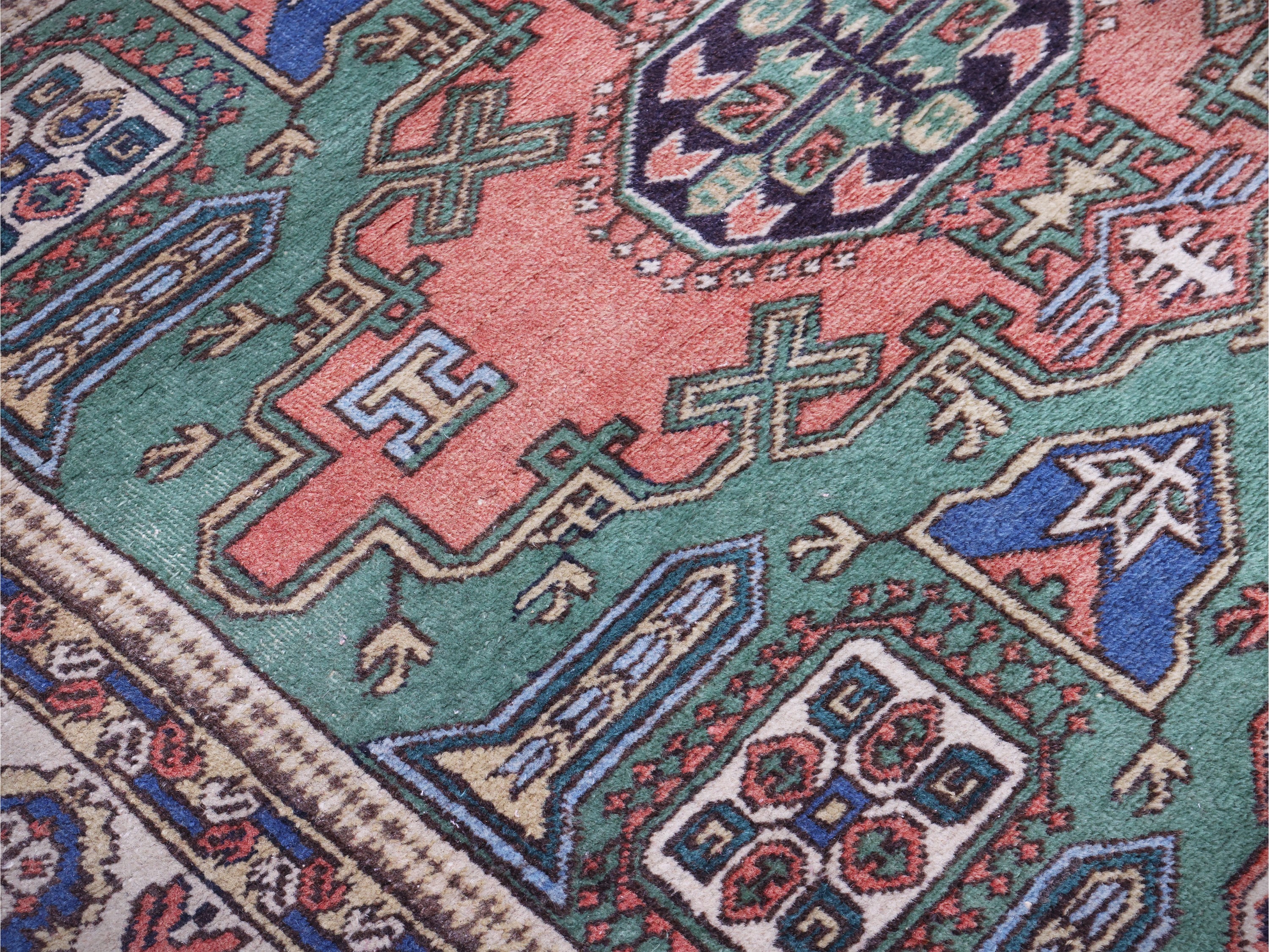 Tappeto persiano, fondo verde con medaglioni rosso-blu e alta bordura