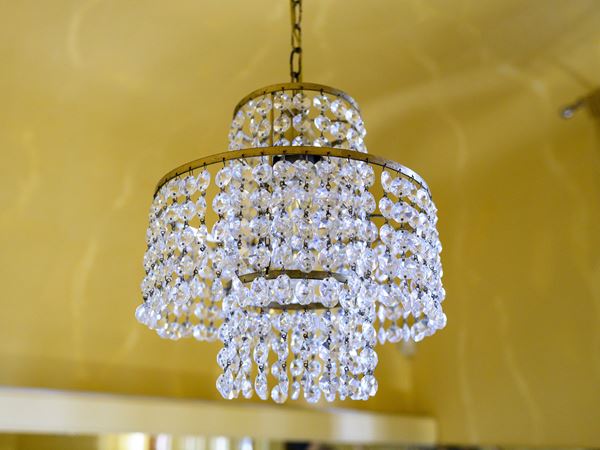 Small chandelier in golden metal and crystal