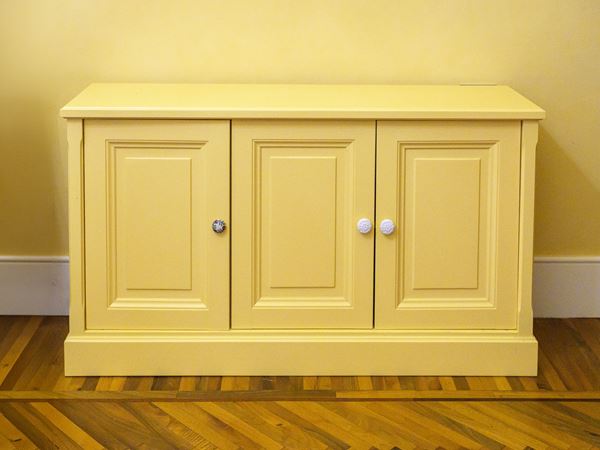 Low cabinet in yellow lacquered wood