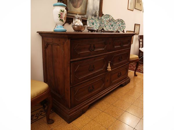 Carved walnut chest of drawers