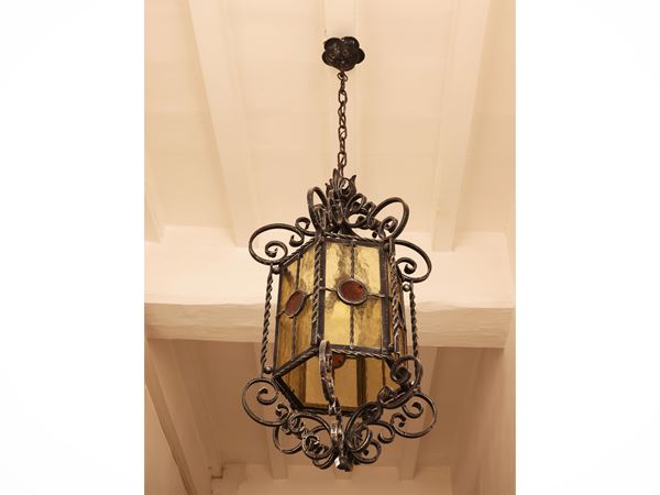 Lantern in wrought iron and colored glass