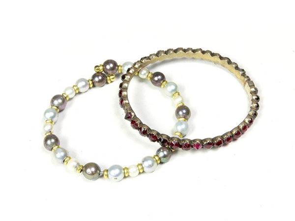 Two Bracelets: one with pearls the other with red crystals