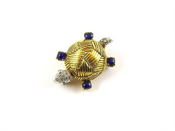 Yellow and white gold tortoise shaped brooch with cabochon cut sapphires and diamonds