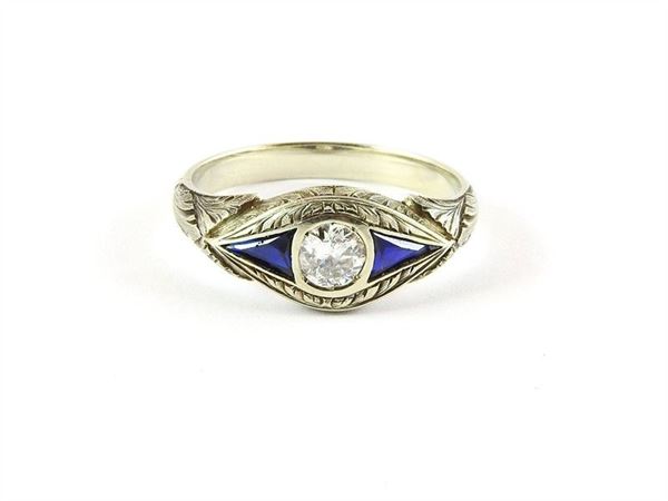 White gold ring with diamond and blue stones