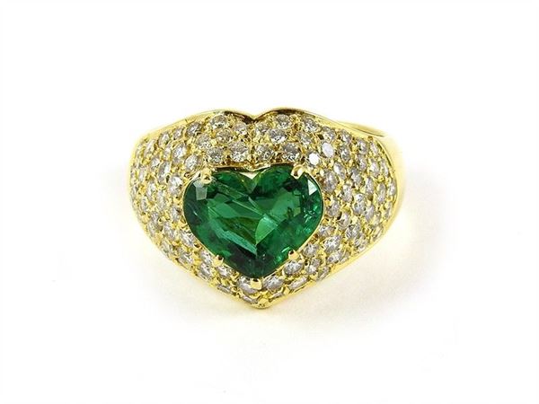 Yellow gold band ring with emerald cut emerald and brilliant cut diamonds
