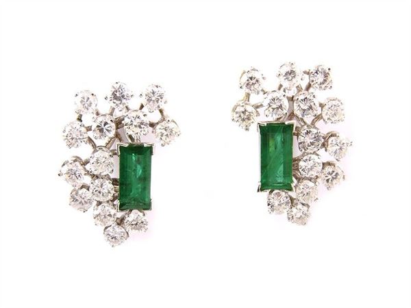 White gold earclips with brilliant cut round diamonds and synthetic emeralds