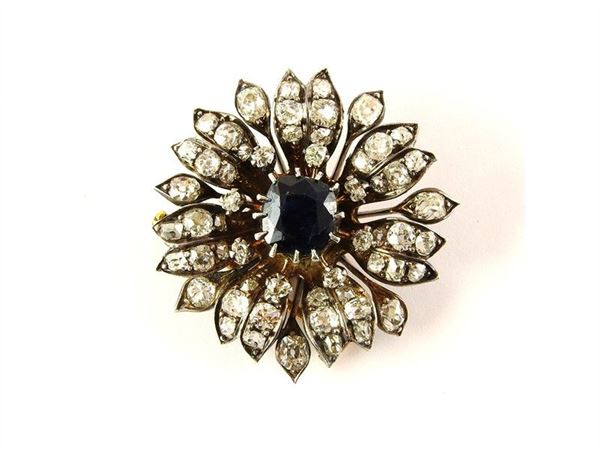 Yellow gold and silver brooch with central sapphire and diamonds