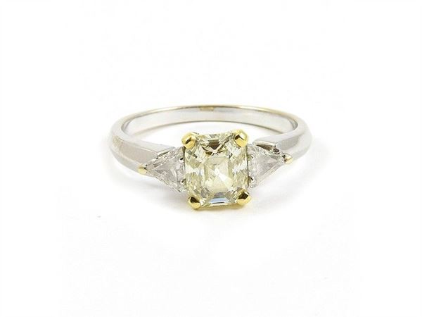 Yellow and white gold ring with emerald cut diamond