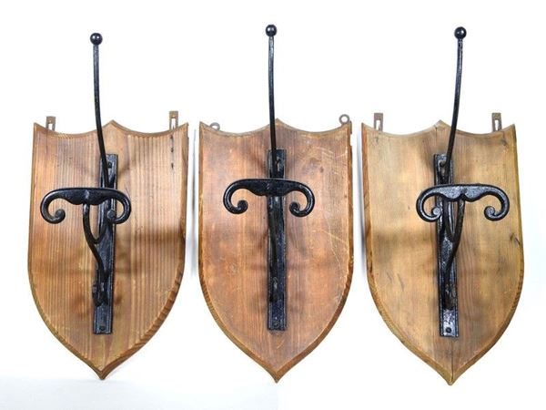 A Set of Three Wrought Iron Wall Coat Racks