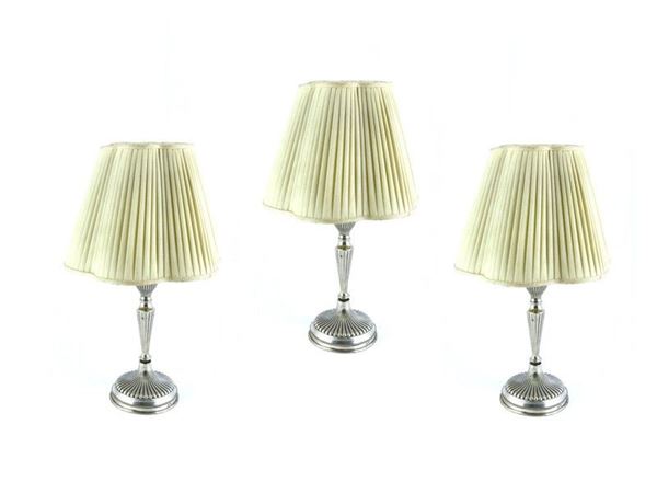 A Set of Three Silver Candlesticks Converted to Lamps