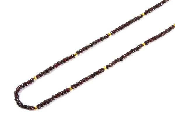 Long faceted garnet necklace with yellow gold wrought ornaments