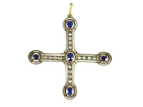 Yellow gold and silver cross shaped pendant with sapphires and diamonds