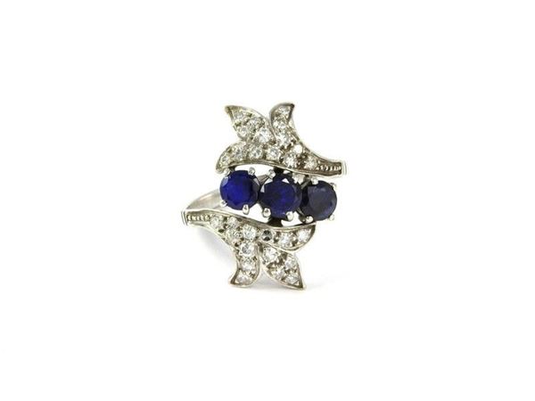 White gold ring set with round sapphires and diamonds