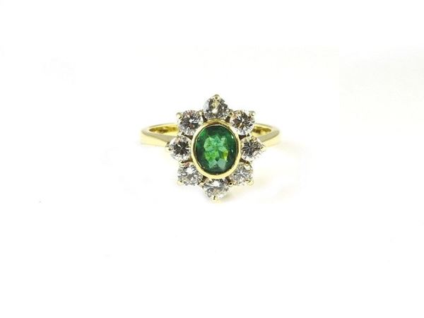 Yellow and white gold daisy ring with emerald and diamonds