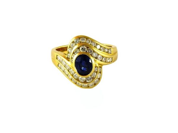 Yellow gold ring with sapphire and diamonds