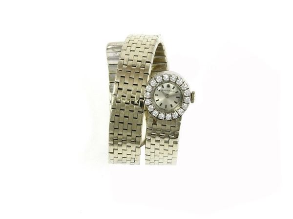 Manual white and yellow gold flexible snake shaped band lady's wristwatch with diamonds