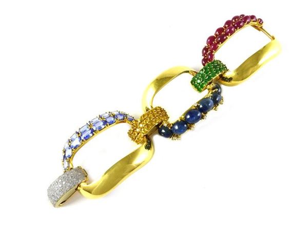 Three linked yellow gold bracelet set with sapphires, rubies, emeralds and diamonds